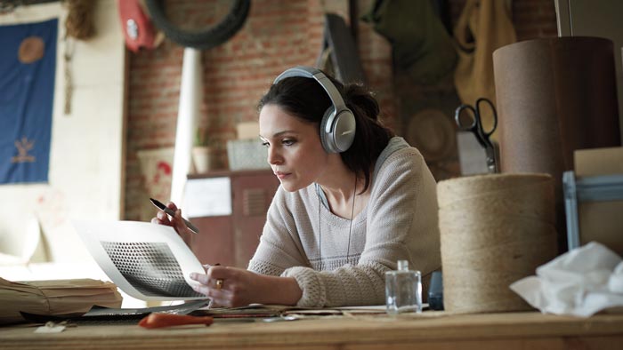 Image of QC35 on woman in design studio.