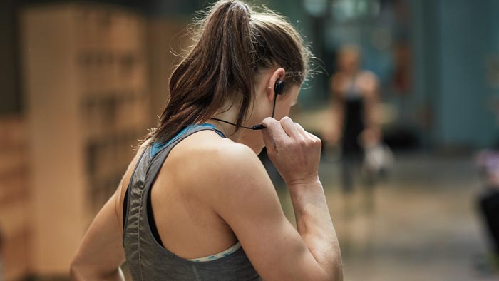Image of SoundSport wireless worn by woman running.