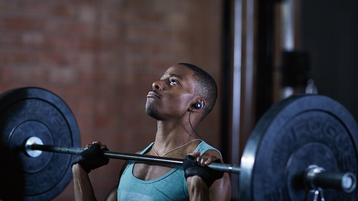 Image of SoundSport wireless worn by man weight-lifting.