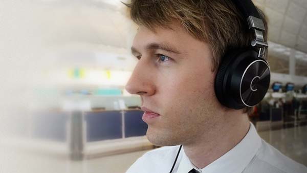 Man wearing Cleer NC headphones on commute