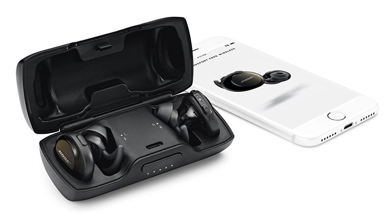 Image of a man sitting on stairs. Bose SoundSport Free wireless headphones.