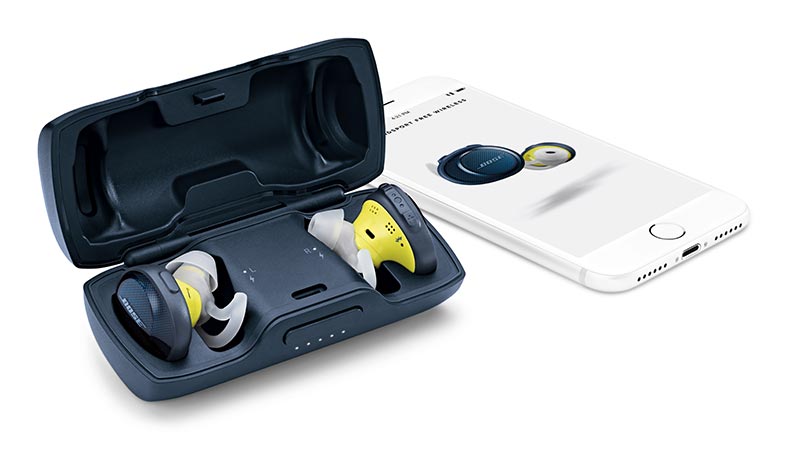 Image of a man sitting on stairs. Bose SoundSport Free wireless headphones.