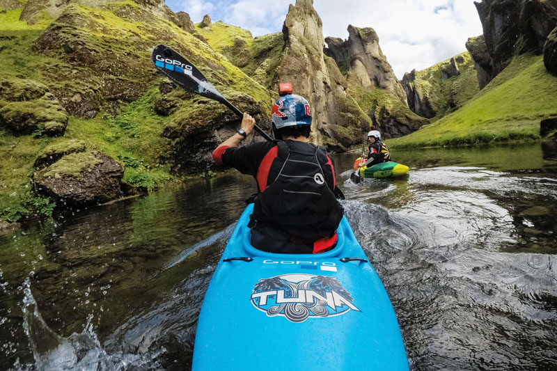Image of man in kayak on river.
