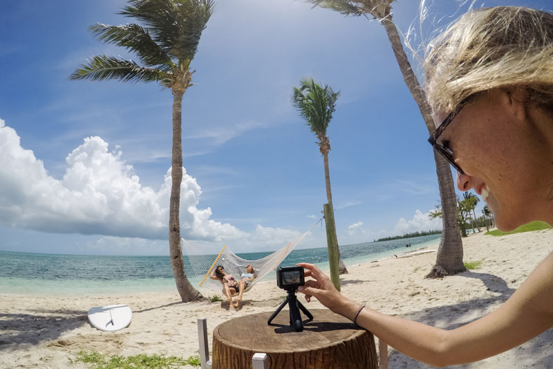 Image of GoPro HERO6 on beach with women on hammock.